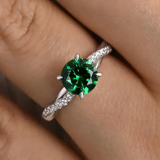 Timeless 1.25ct Twist Round Cut Emerald Green Engagement Ring In Sterling Silver